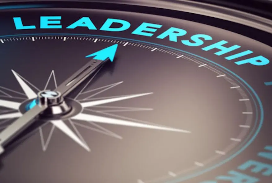 Compass with needle pointing the word leadership with blur effect plus blue and black tones. Conceptual image for illustration of leader motivation